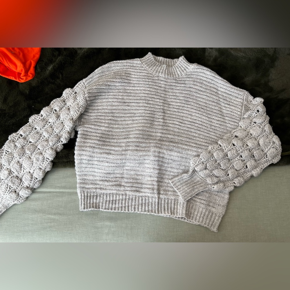 Grey sweater with bobble sleeve detail
